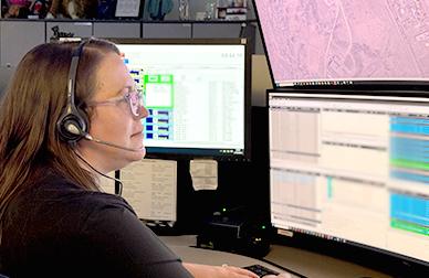 Dispatcher sitting at the console viewing current calls for service